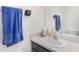 This bathroom features a vanity with a sink, a mirror, and blue towels at 10604 Scenic Hollow Dr, Riverview, FL 33578