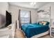 Cozy bedroom featuring a plush bed, ample natural light, and modern decor at 10604 Scenic Hollow Dr, Riverview, FL 33578