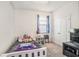 This bedroom is brightly lit and features a twin-size bed, closet, and a ceiling fan at 10604 Scenic Hollow Dr, Riverview, FL 33578