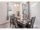 Well-lit dining room with a dark wood table, chandelier, and modern window coverings at 10604 Scenic Hollow Dr, Riverview, FL 33578