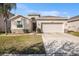 Charming single-story home featuring a two-car garage, manicured lawn, and stone veneer accents at 10604 Scenic Hollow Dr, Riverview, FL 33578