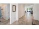 Bright hallway with tile flooring leading to the living area and a bathroom on the left at 10604 Scenic Hollow Dr, Riverview, FL 33578