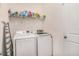 Laundry room with washer, dryer, wire rack and an ironing board at 10604 Scenic Hollow Dr, Riverview, FL 33578