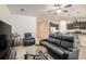 Open-concept living area flowing into the kitchen, featuring dark wood cabinetry at 10604 Scenic Hollow Dr, Riverview, FL 33578