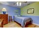 Inviting bedroom featuring hardwood floors, with colorful walls, and natural light at 12009 Steppingstone Blvd, Tampa, FL 33635