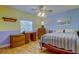 Charming bedroom with bright walls, a ceiling fan, and hardwood floors for a cozy feel at 12009 Steppingstone Blvd, Tampa, FL 33635