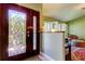 Inviting foyer with an ornate glass front door and decorative shutters in the background at 12009 Steppingstone Blvd, Tampa, FL 33635