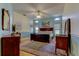 The spacious main bedroom features light blue walls, a ceiling fan, and beautiful wood floors at 12009 Steppingstone Blvd, Tampa, FL 33635