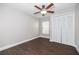 Bedroom with wood-look flooring, ceiling fan, closet, and a window offering natural light at 12050 Stone Crossing Cir, Tampa, FL 33635