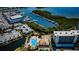 An aerial shot of a waterfront condo community with a pool, clubhouse, and boat docks at 1320 Pasadena S Ave # 605, South Pasadena, FL 33707