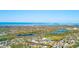 An aerial view of the community and surrounding neighborhood with nearby lakes and the ocean beyond at 13250 Ridge Rd # 10-4, Largo, FL 33778