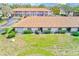 Aerial view of the townhomes with lush green spaces and a view of the rooftops at 13250 Ridge Rd # 10-4, Largo, FL 33778