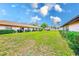 Lush green backyard surrounded by well-maintained townhomes and blue skies at 13250 Ridge Rd # 10-4, Largo, FL 33778