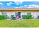 Well-manicured backyard with lush green lawn and a patio featuring a chair and grill at 13250 Ridge Rd # 10-4, Largo, FL 33778