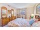 Comfortable bedroom with a large bed, dresser, and natural light from the window at 13250 Ridge Rd # 10-4, Largo, FL 33778