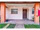 Charming front porch leads to the townhome's inviting entrance with a decorative front door at 13250 Ridge Rd # 10-4, Largo, FL 33778