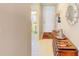 Hallway with tiled floor features a decorative console table and views into the adjacent rooms at 13250 Ridge Rd # 10-4, Largo, FL 33778