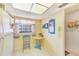 A cheerful breakfast nook with a table, chair, and bright window at 13250 Ridge Rd # 10-4, Largo, FL 33778