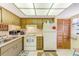 A functional kitchen with a range, refrigerator, and ample cabinet space at 13250 Ridge Rd # 10-4, Largo, FL 33778