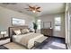 Serene bedroom with neutral walls, dark wood-look floors, a ceiling fan, and abundant natural light at 14334 Channel Dr, Largo, FL 33774