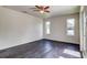 Bright bedroom features two windows, ceiling fan and dark tile flooring at 14334 Channel Dr, Largo, FL 33774