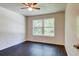 Bedroom is a bright space, complete with sleek ceiling fan and a large window offering tranquil outdoor views at 14334 Channel Dr, Largo, FL 33774