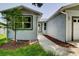 The home's entrance with a well-manicured lawn and new, modern paint scheme at 14334 Channel Dr, Largo, FL 33774