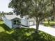 Charming single-story home with well-maintained lawn, attached two-car garage, and mature landscaping at 14334 Channel Dr, Largo, FL 33774