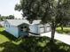 Exterior view of home featuring a two-car garage and well maintained lawn at 14334 Channel Dr, Largo, FL 33774
