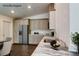 Bright kitchen featuring modern appliances, light wood cabinets, beautiful countertops and wood-look floors at 14334 Channel Dr, Largo, FL 33774
