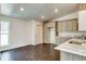 Open kitchen showcasing wood-look floors, stylish cabinetry, and a breakfast bar for casual dining at 14334 Channel Dr, Largo, FL 33774