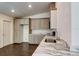 Well-equipped kitchen featuring modern stainless steel appliances, wood-look floors, and stylish countertops at 14334 Channel Dr, Largo, FL 33774