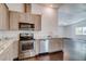 Modern kitchen with wood-look floors, light wood cabinets, stainless steel appliances and sleek countertops at 14334 Channel Dr, Largo, FL 33774