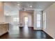Bright living room has wood-look tile, ample lighting, and an open doorway leading to another space at 14334 Channel Dr, Largo, FL 33774
