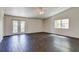 Bright living room with a ceiling fan and access to the outside through double doors at 14334 Channel Dr, Largo, FL 33774