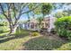 Backyard featuring a screened-in lanai and hot tub at 1434 Glengarry Dr, Palm Harbor, FL 34684
