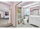 Bathroom with mirrored sliding door, shower curtain, and vanity at 1434 Glengarry Dr, Palm Harbor, FL 34684