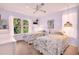 Bright, airy bedroom with two beds, large windows, and matching lamps at 1434 Glengarry Dr, Palm Harbor, FL 34684