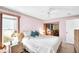 Cozy bedroom with a ceiling fan, light pink walls, and a window for natural light at 1434 Glengarry Dr, Palm Harbor, FL 34684