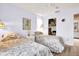 Bedroom featuring two beds, hardwood floors, and access to an organized closet at 1434 Glengarry Dr, Palm Harbor, FL 34684