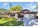 Charming single-story home with stone accents, a well-manicured lawn, and a two-car garage at 1434 Glengarry Dr, Palm Harbor, FL 34684