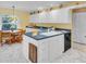 Kitchen with an island with a breakfast bar next to the dining area at 1434 Glengarry Dr, Palm Harbor, FL 34684