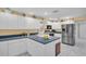 Bright eat-in kitchen with white cabinets, blue countertops, and stainless steel appliances at 1434 Glengarry Dr, Palm Harbor, FL 34684