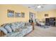 Comfortable living room with bright walls and wood-look flooring at 1434 Glengarry Dr, Palm Harbor, FL 34684