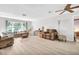 Bright living room with large window, neutral walls, light wood floors, and comfortable furnishings at 1434 Glengarry Dr, Palm Harbor, FL 34684