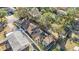 This aerial view showcases the backyard, detached garage, patio, and mature trees surrounding the property at 15530 Morgan St, Clearwater, FL 33760