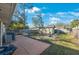 Spacious backyard with a patio, grill, shed, and seating surrounding a fire pit at 15530 Morgan St, Clearwater, FL 33760