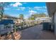 Private backyard featuring a patio, playhouse, and fenced yard with mature trees at 15530 Morgan St, Clearwater, FL 33760