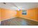 Bright bedroom with hardwood floors, ceiling fan, and large window allowing natural light at 15530 Morgan St, Clearwater, FL 33760