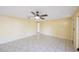 Empty room features tile floors, ceiling fan, and access to additional rooms at 15530 Morgan St, Clearwater, FL 33760